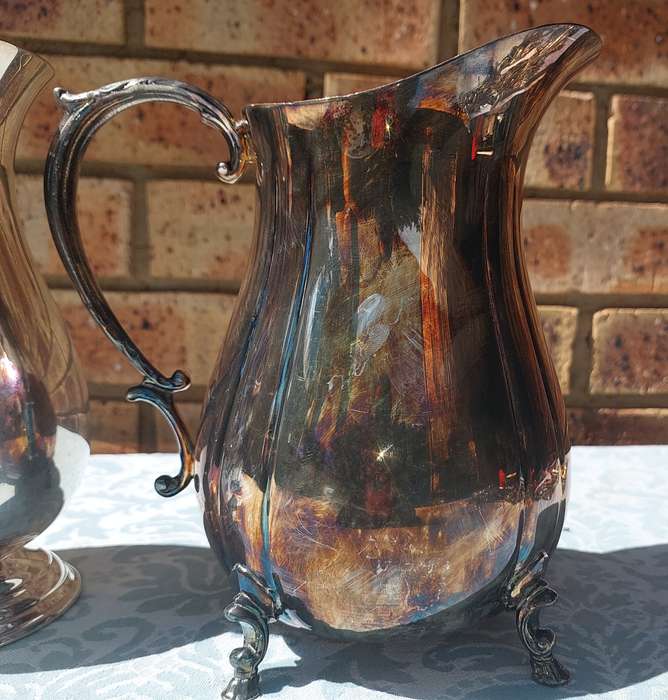 AN ANTIQUE COLLECTION SILVER PLATED WATER JUGS