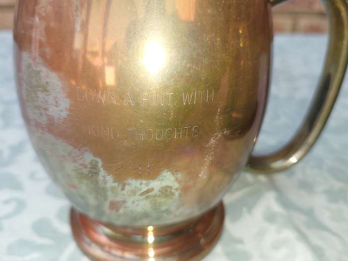 A SILVER-PLATED ICE BUCKET AND A SILVER PLATED ON COPPER PINT BEER MUG