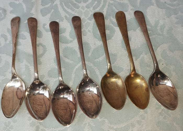 A VINTAGE COLLECTION OF TEASPOONS SOLD AS IS