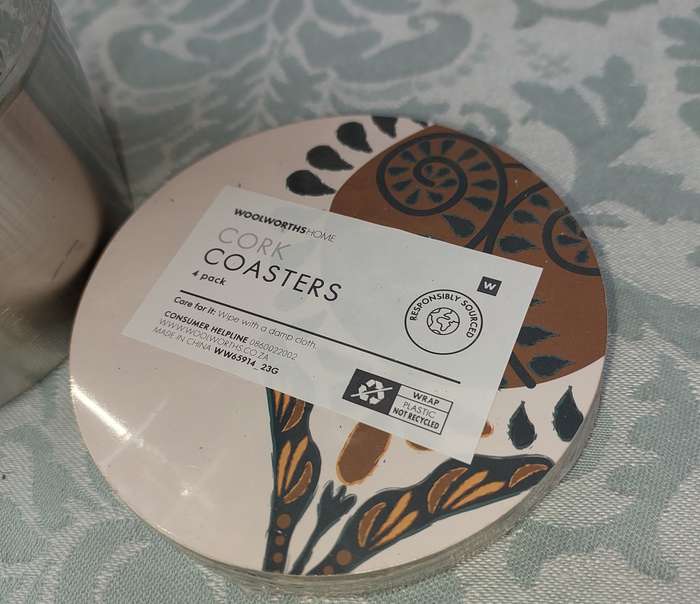 A STAINLESS STEEL ICE BUCKET AND A SET OF 4 COASTERS