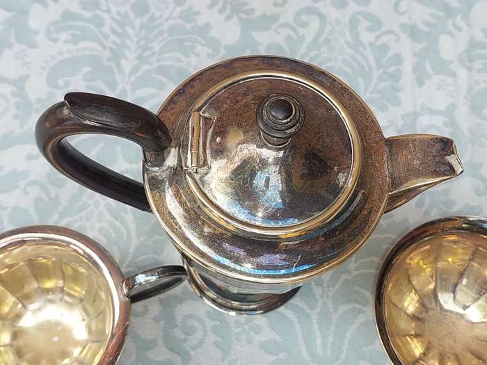 AN ANTIQUE TEA JUG SET MADE IN SHEFFIELD ENGLAND