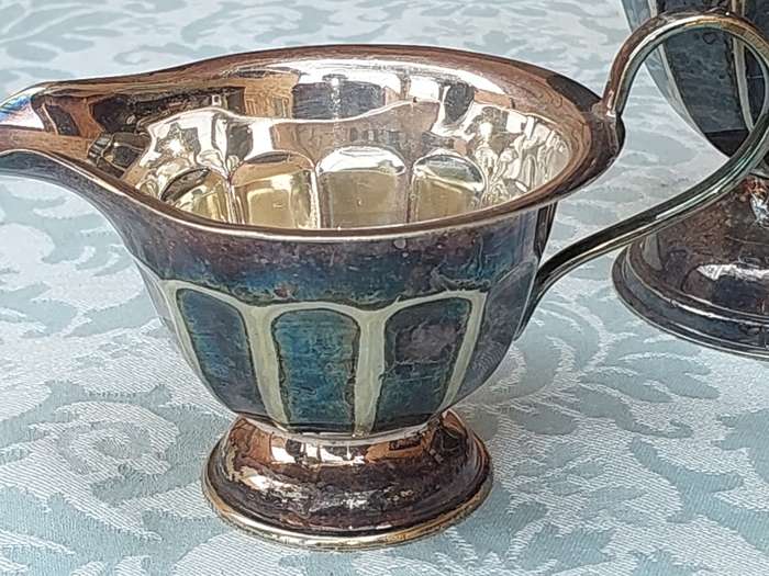 AN ANTIQUE TEA JUG SET MADE IN SHEFFIELD ENGLAND