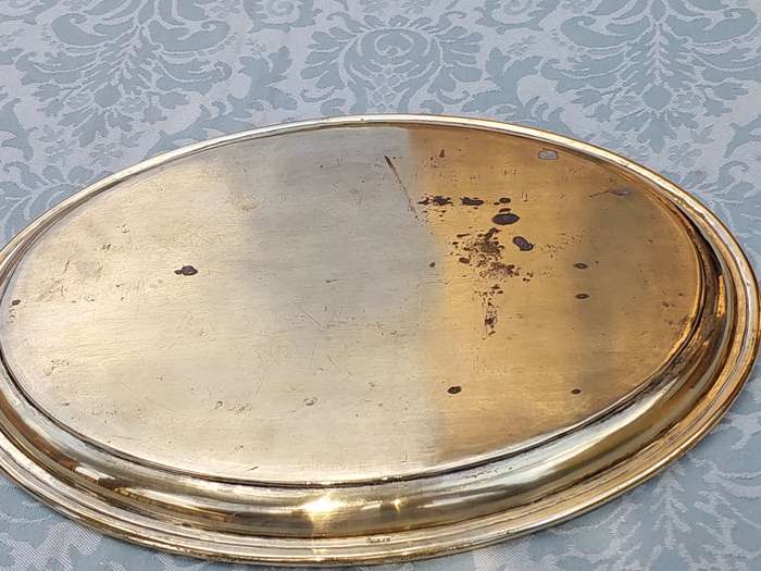 A SILVER-PLATED ON BRASS PLAQUE WITH ENGRAVINGS ON IT SOLD AS IS