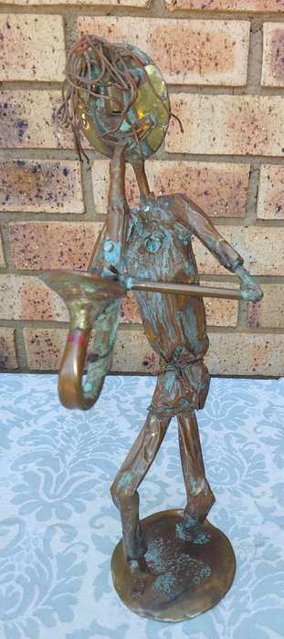 A COLLECTION OF COPPER FIGURINE ART SCULPTURES A PIANIST ,A PIANO WITH A SAXOPHONIST AND A BICYCLE
