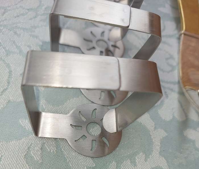 A VINTAGE SET ARTVARK SALAD LADELS AND A SET OF 8 STAINLESS STEEL NAPKIN RINGS