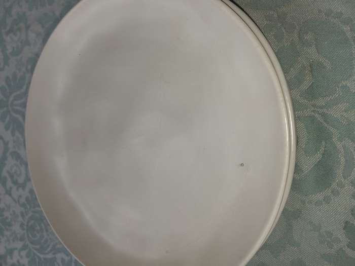 A 12 PIECE CERAMIC DINNER SET OFF WHITE IN COLOUR SOLD AS IS