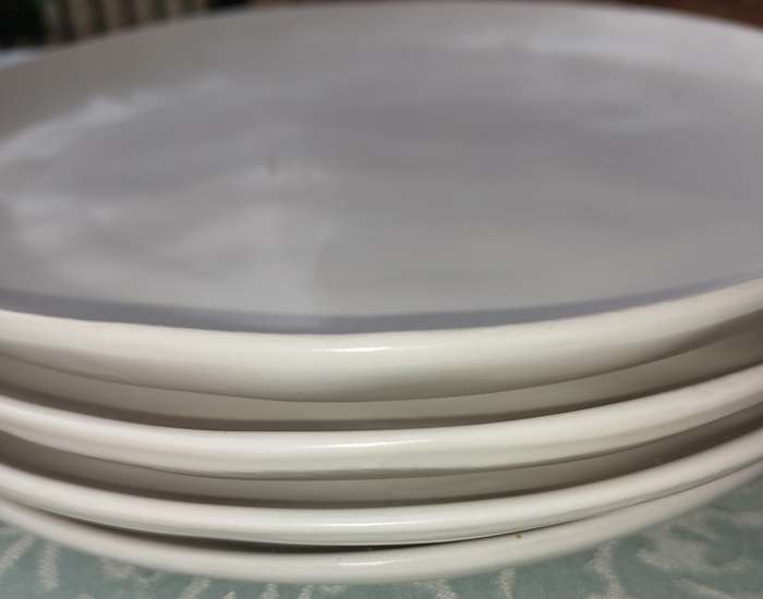 A 12 PIECE CERAMIC DINNER SET OFF WHITE IN COLOUR SOLD AS IS