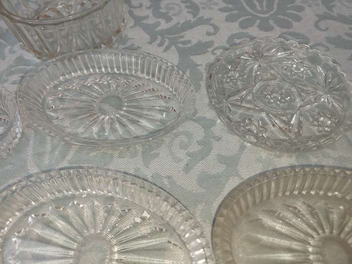 A COLLECTION OF COASTER WITH SILVER PLATED RIMS AND ORNATE CONDIMENTS OVAL MINIATURE PLATTERS