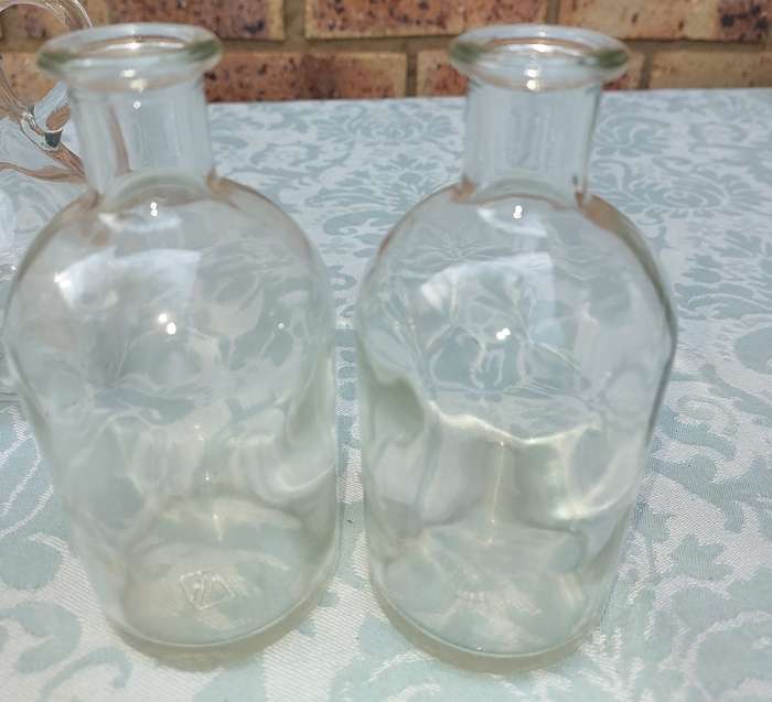 A COLLECTION OF GLASS SAUCE BOTTLES SOLD AS IS