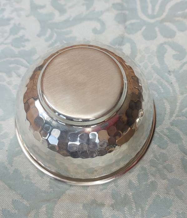 A STAINLESS STEEL BOWL CANDLE HOLDER