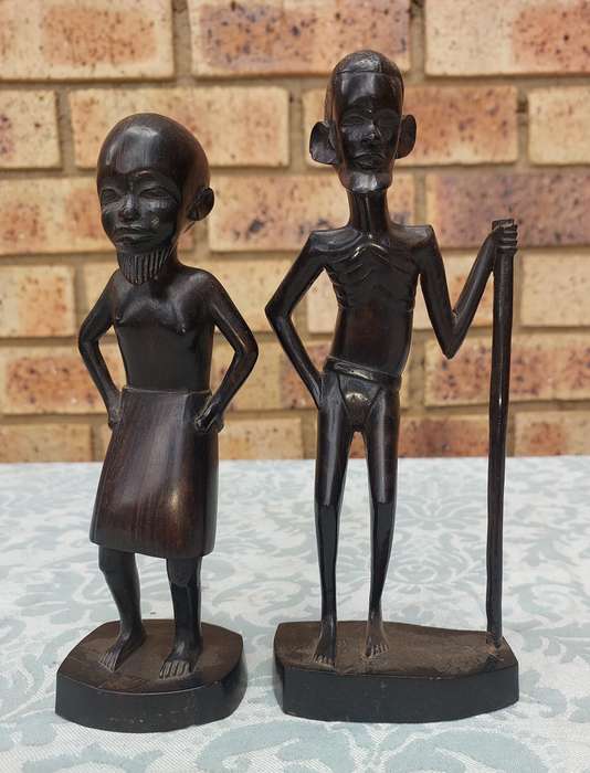 A PAIR OF VINTAGE HARD WOOD AFRICAN ART SCULPTURES SOLD AS IS