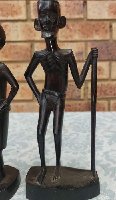A PAIR OF VINTAGE HARD WOOD AFRICAN ART SCULPTURES SOLD AS IS