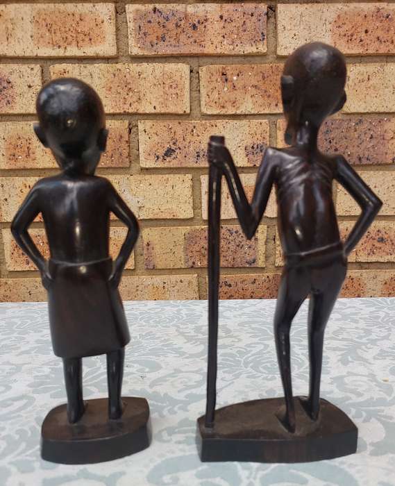 A PAIR OF VINTAGE HARD WOOD AFRICAN ART SCULPTURES SOLD AS IS
