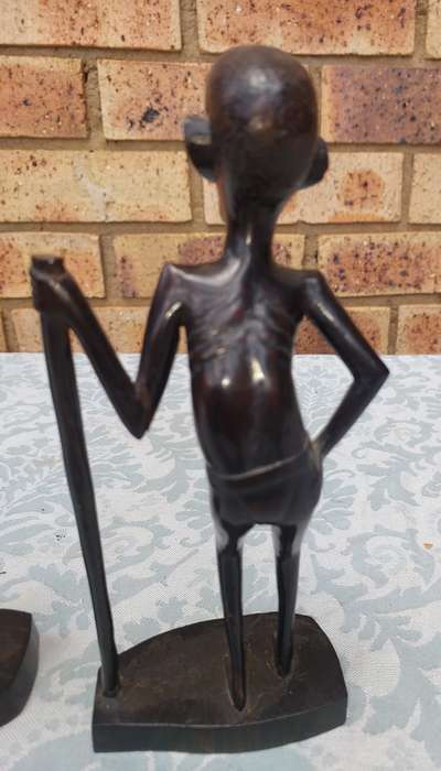 A PAIR OF VINTAGE HARD WOOD AFRICAN ART SCULPTURES SOLD AS IS