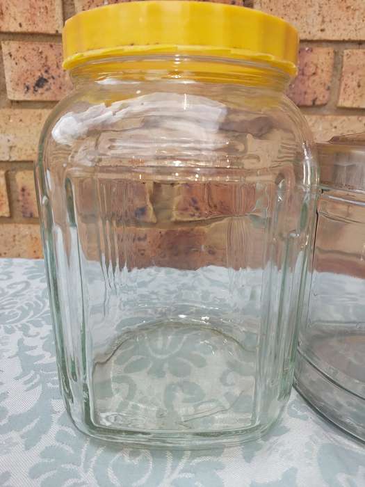 A COLLECTION OF GLASS STORAGE JARS SOLD AS IS