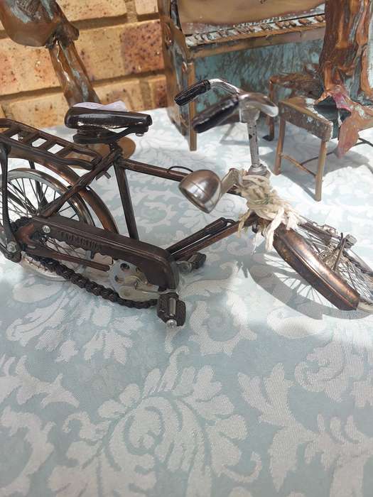 A COLLECTION OF COPPER FIGURINE ART SCULPTURES A PIANIST ,A PIANO WITH A SAXOPHONIST AND A BICYCLE