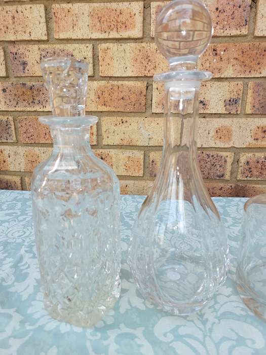 A vintage joblot decanters and vase sold as is