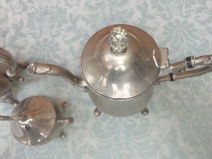 A SILVER PLATED VINTAGE TEAPOT SET SOLD AS IS
