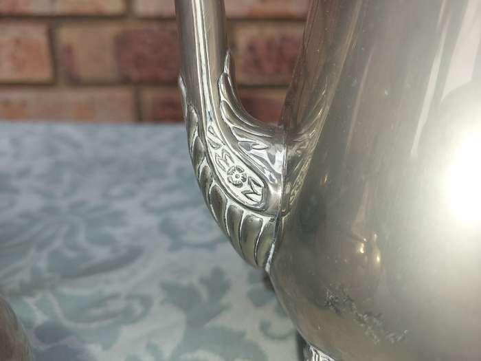 A SILVER PLATED VINTAGE TEAPOT SET SOLD AS IS