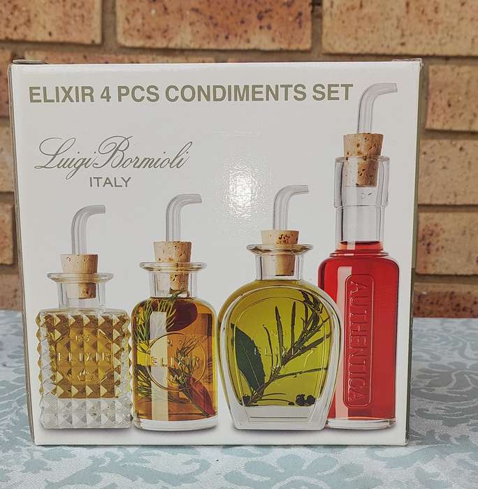 A FLIXIR 4 PIECE CONDIMENTS SET BY LUIGI BORMIOLI ITALY IN ITS ORIGINAL BOX NEVER USED SOLD AS IS