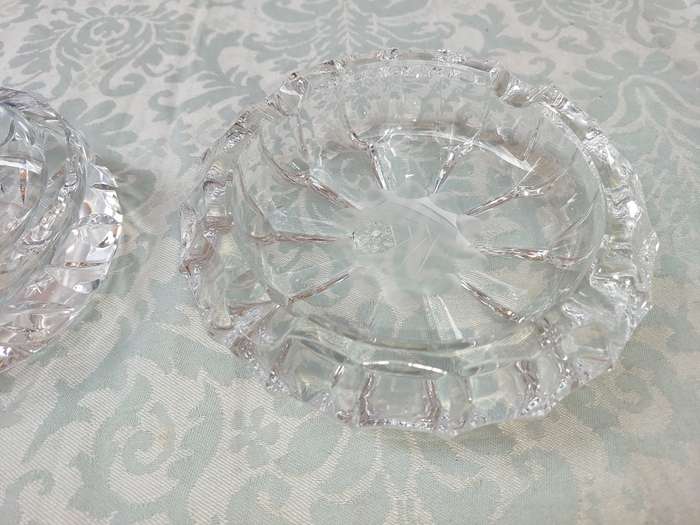 A PAIR OF GLASS ASH TRAYS SOLD AS IS