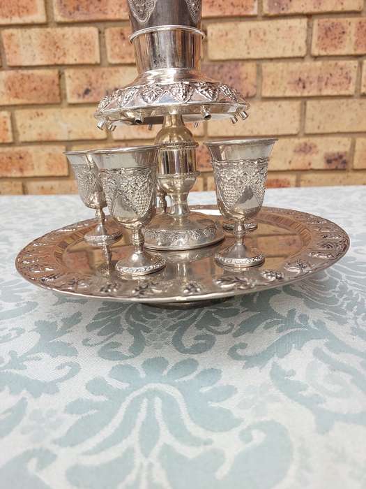 A VINTAGE KIDDUSH SET WITH ONE CUP MISSING SOLD AS IS