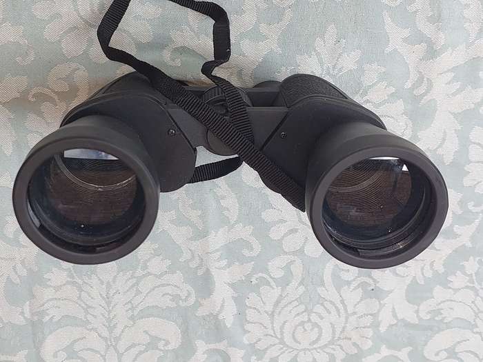 A USED 60X60 BINOCULARS SOLD AS IS