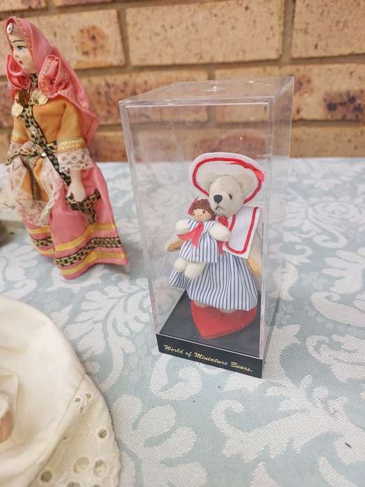 A VINTAGE COLLECTION OF DOLLS AND FIGURINES SOLD AS IS