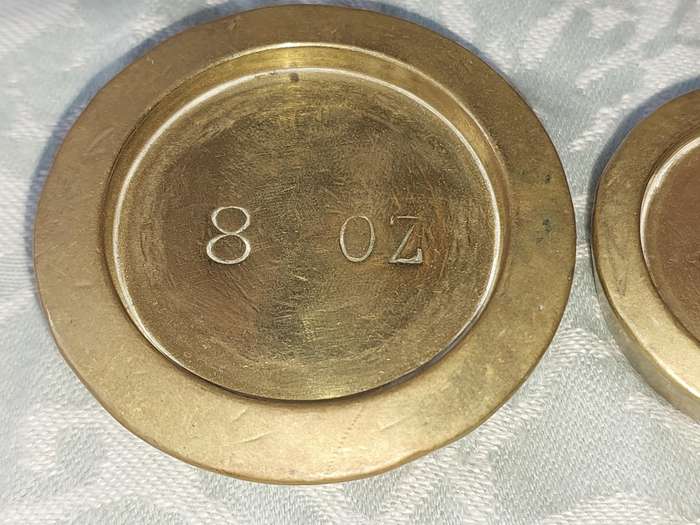 A VINTAGE CAST IRON AND BRONZE SCALE WITH THE BRONZE WEIGHTS SOLD AS IS