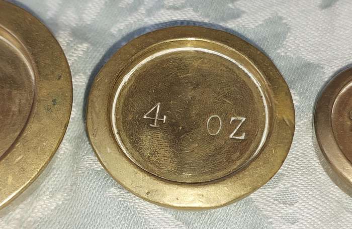 A VINTAGE CAST IRON AND BRONZE SCALE WITH THE BRONZE WEIGHTS SOLD AS IS