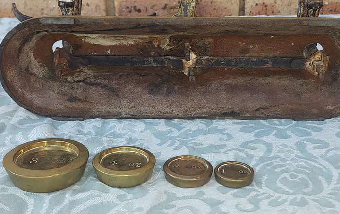 A VINTAGE CAST IRON AND BRONZE SCALE WITH THE BRONZE WEIGHTS SOLD AS IS