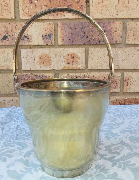 A VINTAGE SILVER PLATED ICE BUCKET SOLD AS IS