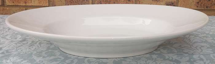 AN OVAL PORCELAIN PLATTER SOLD AS IS