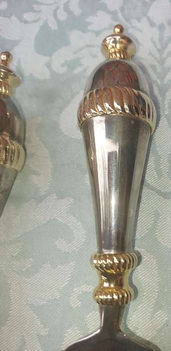 A SET OF ART DECOR STAINLESS STEEL AND BRASS SERVING CUTLERY