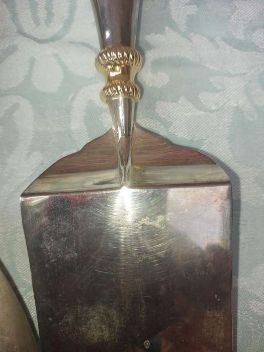 A SET OF ART DECOR STAINLESS STEEL AND BRASS SERVING CUTLERY