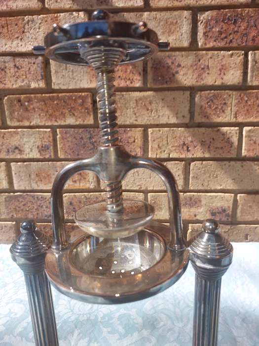 A VINTAGE FRENCH DUCK AND LOBSTER PRESS SILVER PLATED WITH WOODEN BASE SOLD AS IS