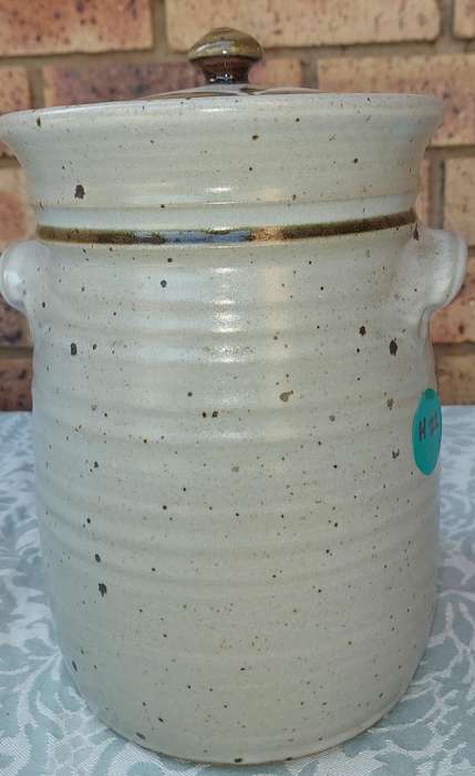A CERAMIC POTTERY OLIVE JAR WITH A LID SOLD AS IS