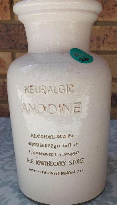 AN ANTIQUE CARAMIA STONE WARE STORAGE BOTTLE SOLD AS IS