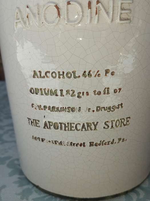 AN ANTIQUE CARAMIA STONE WARE STORAGE BOTTLE SOLD AS IS