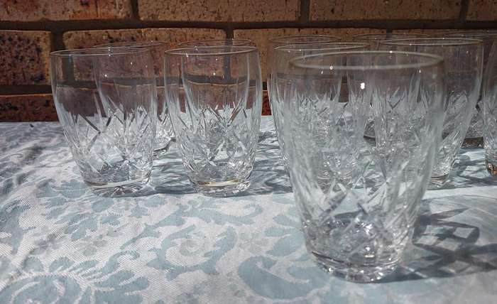 A SET OF 11 CRYSTAL GLASSES SOLD AS IS