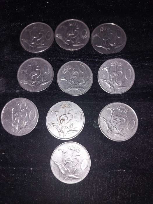A COLLECTION OF 10 VINTAGE  SOUTH AFRICAN 50 CENTS COINS SOLD AS IS