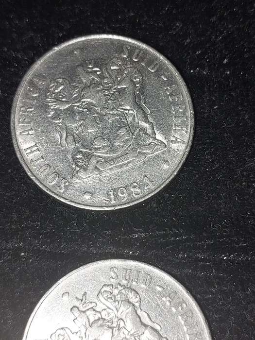 A COLLECTION OF 10 VINTAGE  SOUTH AFRICAN 50 CENTS COINS SOLD AS IS