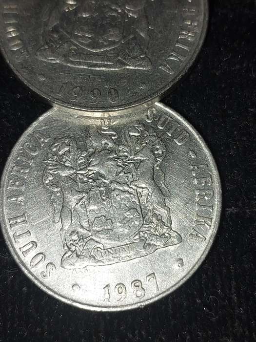 A COLLECTION OF 10 VINTAGE  SOUTH AFRICAN 50 CENTS COINS SOLD AS IS