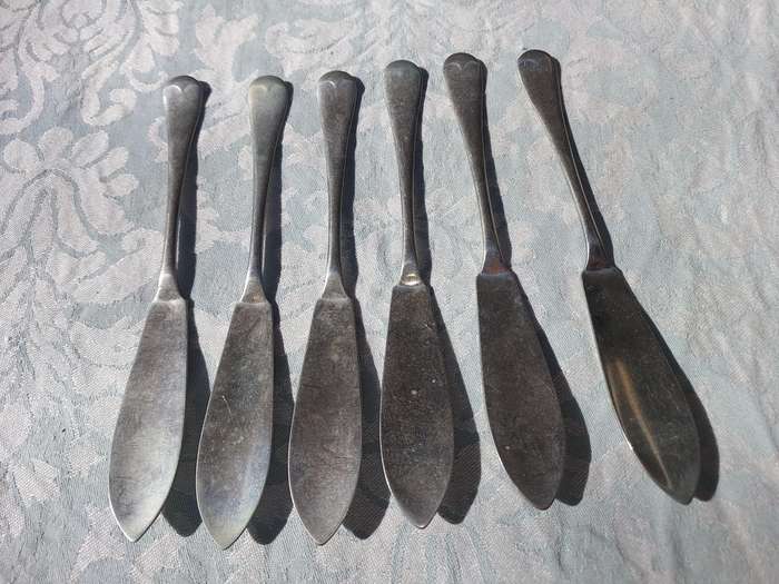 AN ANTIQUE SET OF ATLAS NICKLE SILVER FISH KNIVES SOLD AS IS