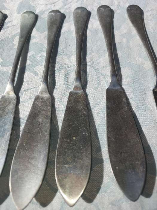 AN ANTIQUE SET OF ATLAS NICKLE SILVER FISH KNIVES SOLD AS IS