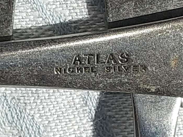 AN ANTIQUE SET OF ATLAS NICKLE SILVER FISH KNIVES SOLD AS IS