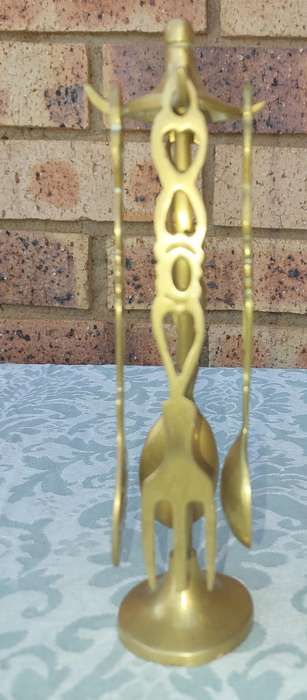 AN ART DECOR BRASS STAND WITH CUTLERY SOLD AS IS