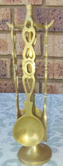AN ART DECOR BRASS STAND WITH CUTLERY SOLD AS IS