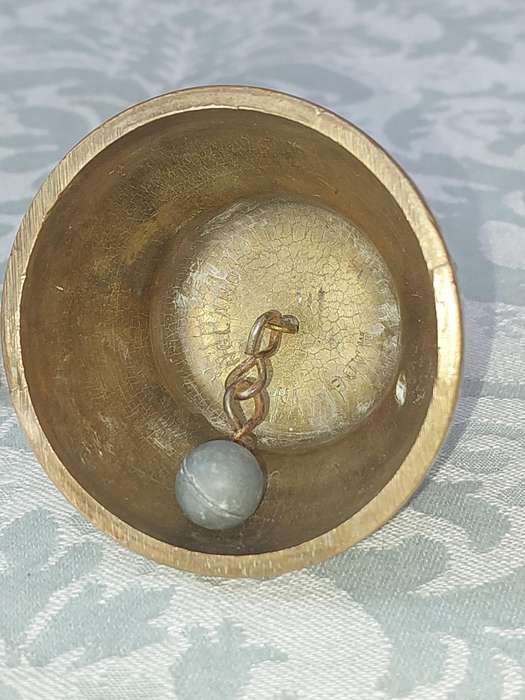 A VINTAGE BRASS VASE AND A BELL SOLD AS IS