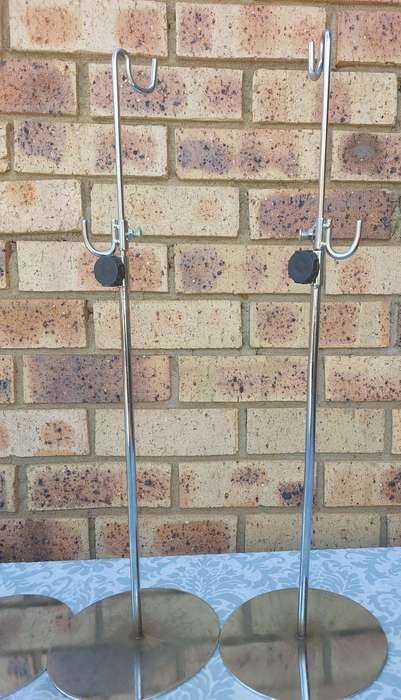 A COLLECTION OF 5 STAINLESS STEEL TABLE STANDS SOLD AS IS